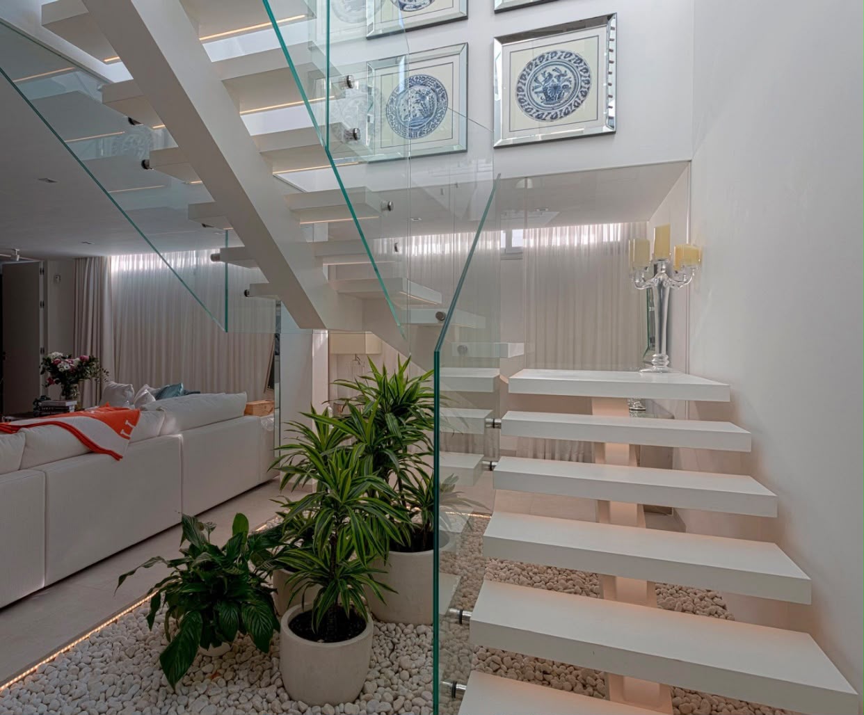 Floating white staircase with glass balustrade