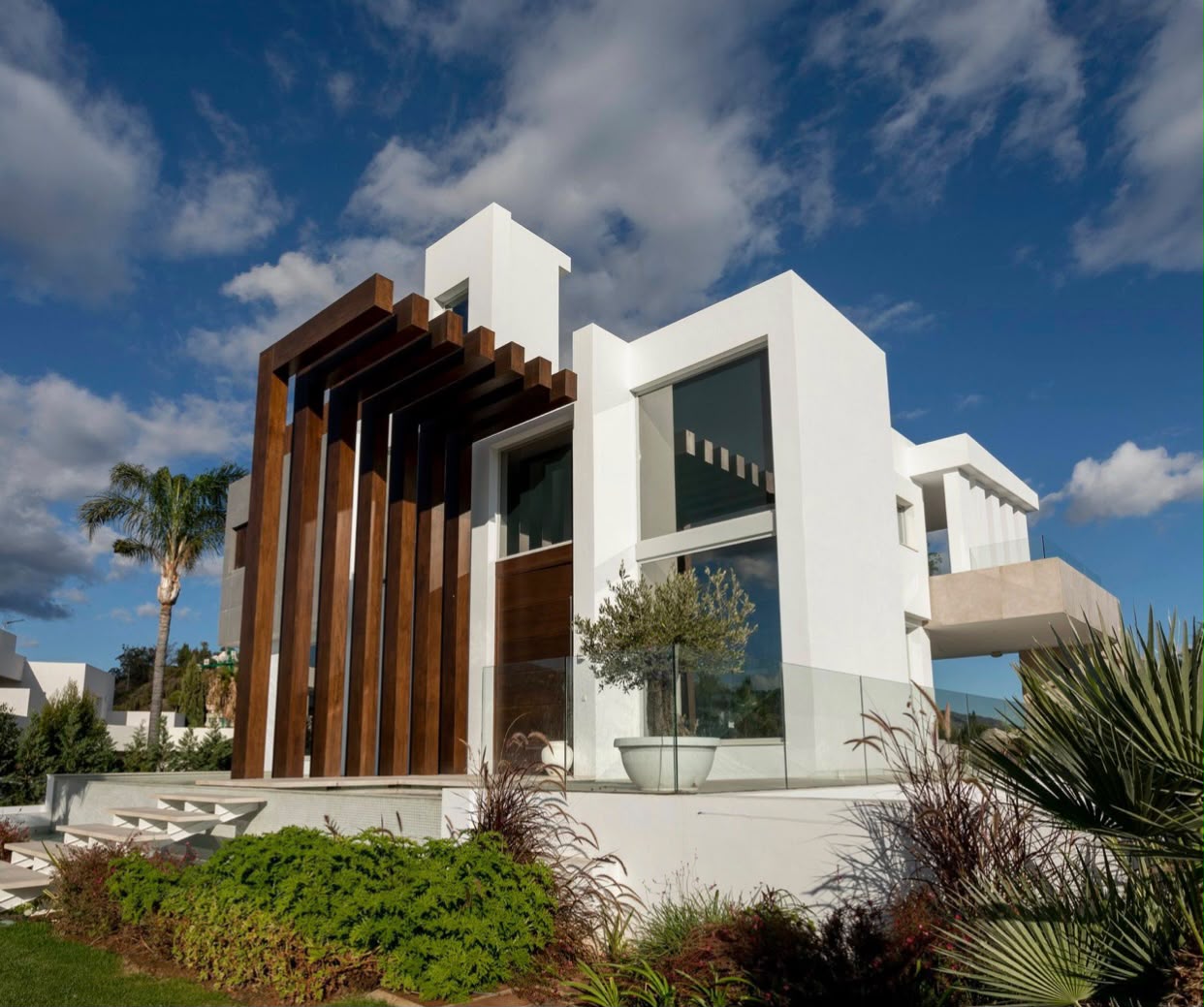 Villa facade with vertical timber screen against the sky